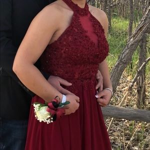 A long, burgundy red prom dress